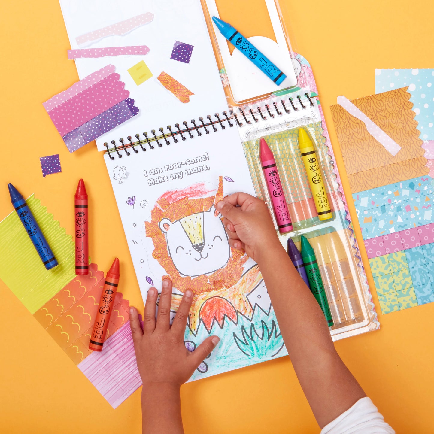 iHeartArt JR Art on the Go! Safari Collage – A travel-friendly collage-making set.  A kid painting a lion inside the set.