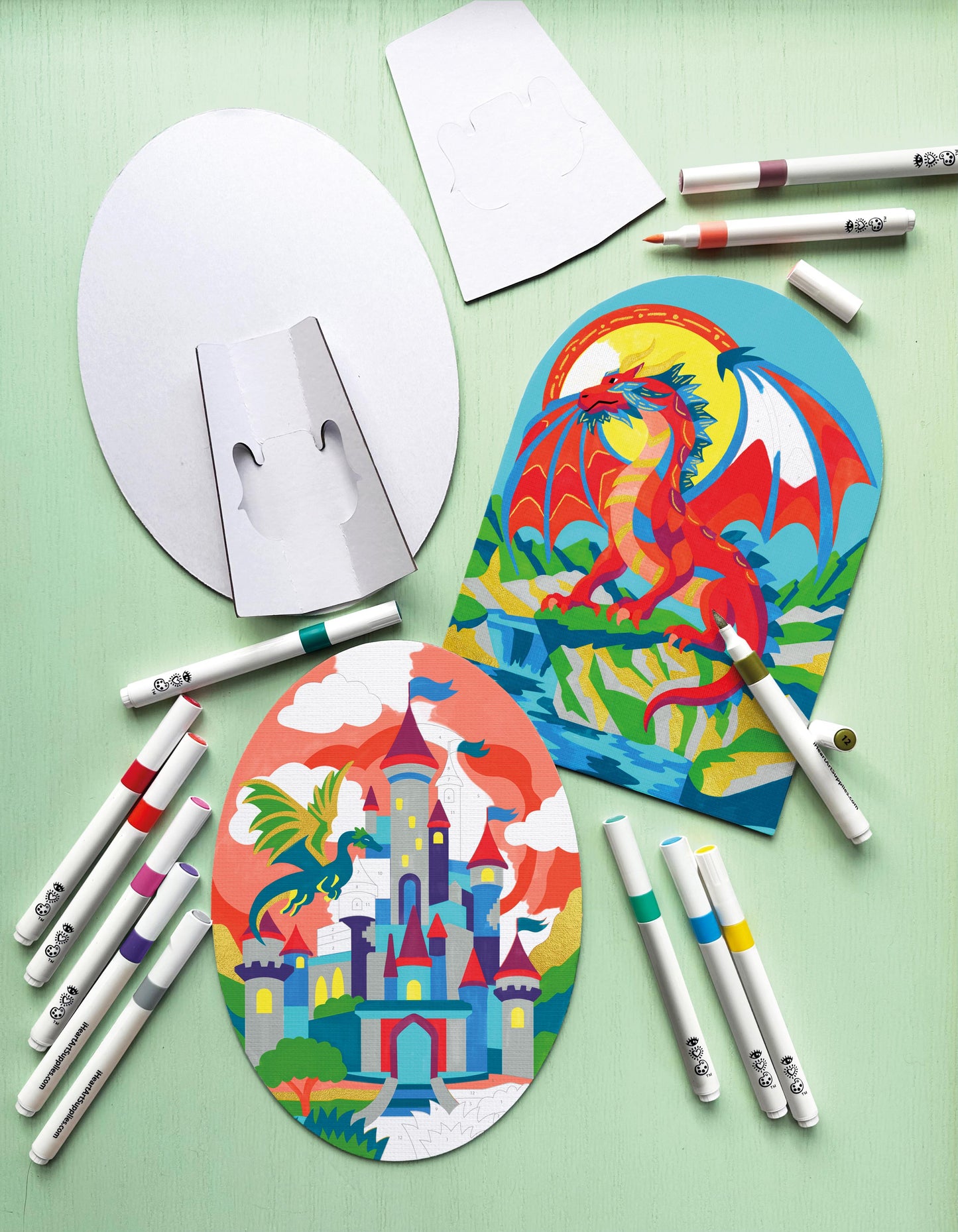 Markers and canvas on a green background